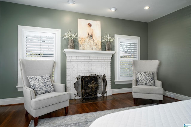 bedroom featuring hardwood / wood-style flooring and a fireplace