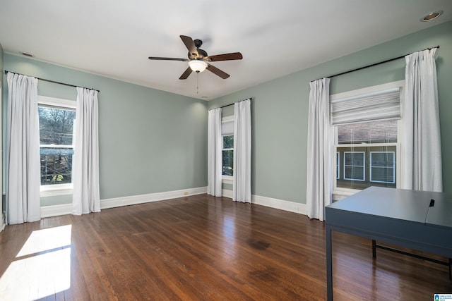 unfurnished room with dark wood-type flooring and ceiling fan