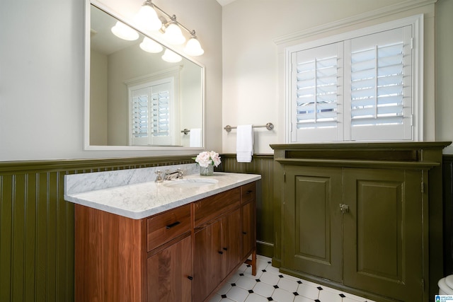 bathroom with vanity and wooden walls