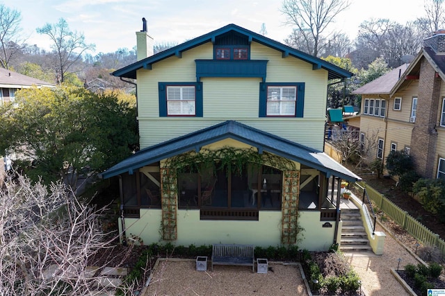 back of house featuring a sunroom