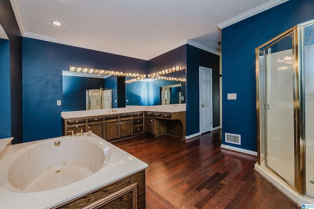 bathroom with vanity, wood-type flooring, ornamental molding, and separate shower and tub