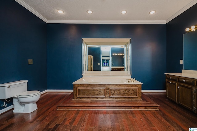 bathroom featuring hardwood / wood-style flooring, a tub to relax in, ornamental molding, and toilet