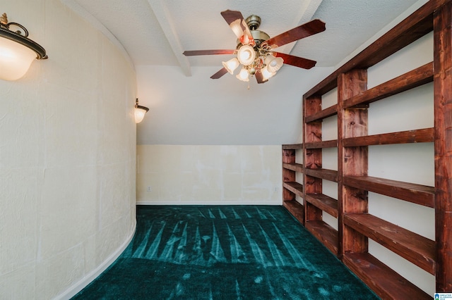 bonus room with ceiling fan, a textured ceiling, and dark colored carpet