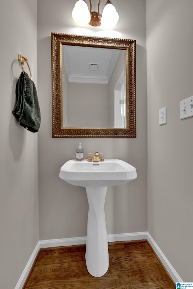 bathroom featuring hardwood / wood-style flooring and ornamental molding