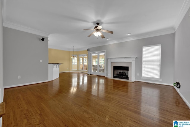 unfurnished living room with dark wood-type flooring, ceiling fan, and ornamental molding