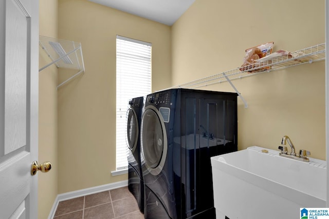 washroom featuring separate washer and dryer, sink, and tile patterned flooring