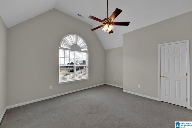 carpeted empty room featuring ceiling fan and vaulted ceiling