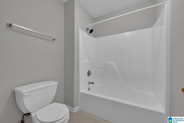 bathroom featuring tile patterned flooring, shower / bathtub combination, and toilet