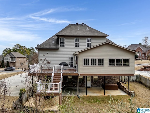 rear view of house featuring a deck and a patio area