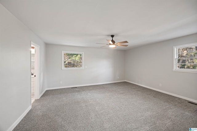 carpeted empty room featuring ceiling fan