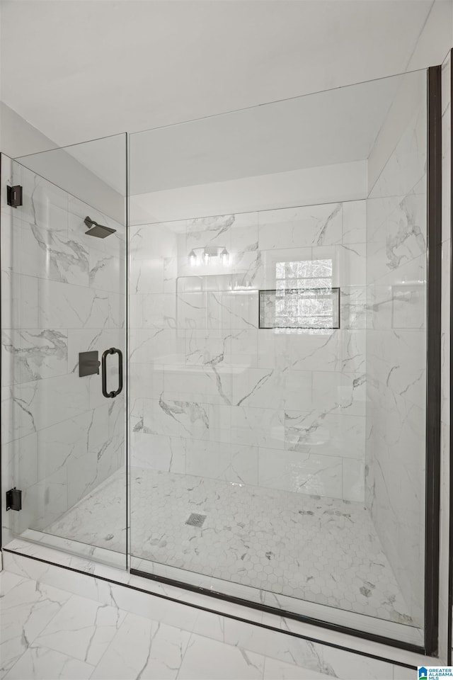 bathroom with a shower with shower door