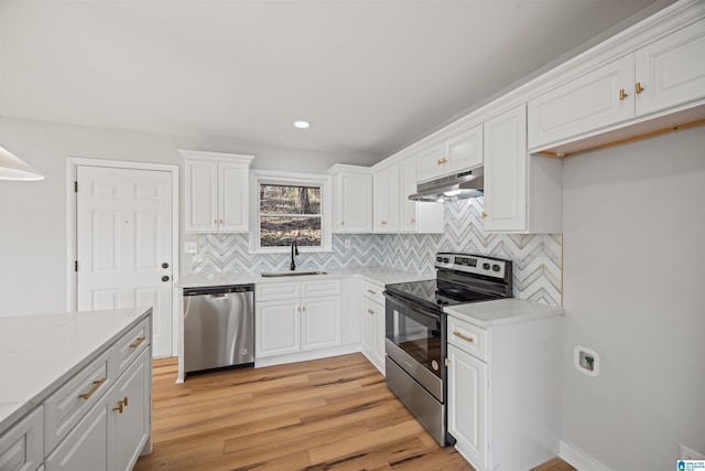 kitchen featuring white cabinetry, sink, light stone counters, light hardwood / wood-style floors, and stainless steel appliances