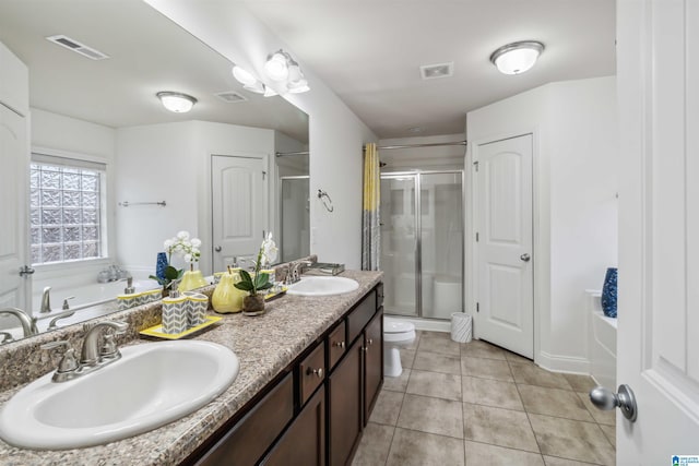 full bathroom with tile patterned flooring, vanity, shower with separate bathtub, and toilet