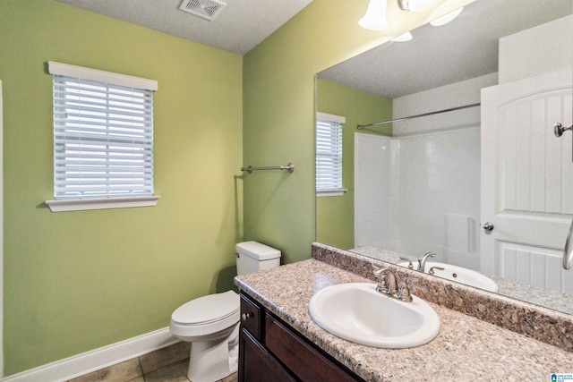 bathroom featuring tile patterned flooring, vanity, walk in shower, and toilet