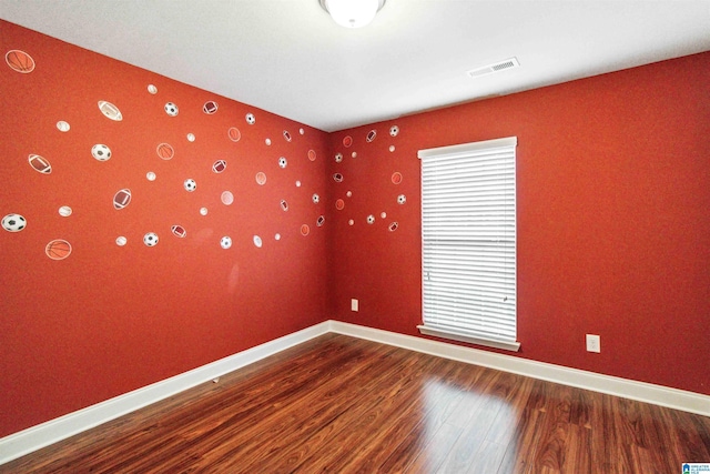 empty room with hardwood / wood-style floors and a wealth of natural light