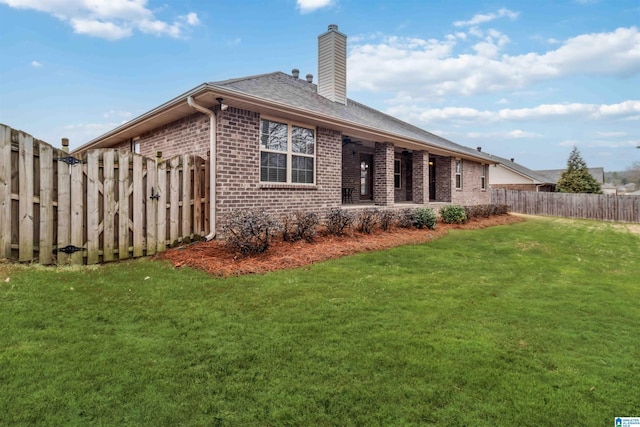 rear view of property with a yard