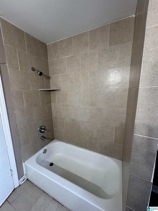 bathroom with tile patterned floors and tiled shower / bath combo