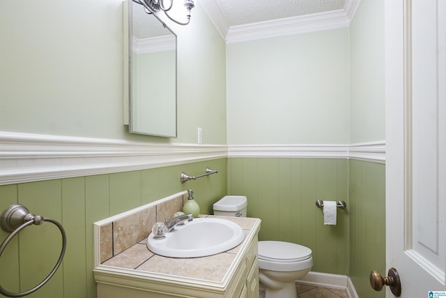 bathroom with ornamental molding, toilet, a textured ceiling, and vanity