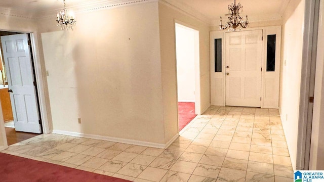 foyer entrance featuring crown molding and a chandelier