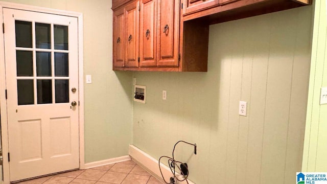 washroom featuring cabinets, washer hookup, and light tile patterned floors