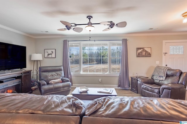 living room featuring light hardwood / wood-style flooring, ornamental molding, and ceiling fan