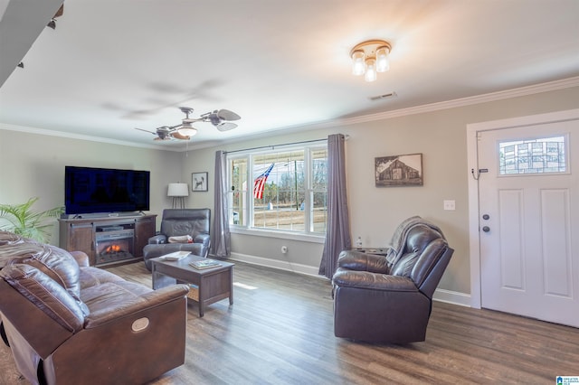 living room featuring crown molding, wood-type flooring, and ceiling fan