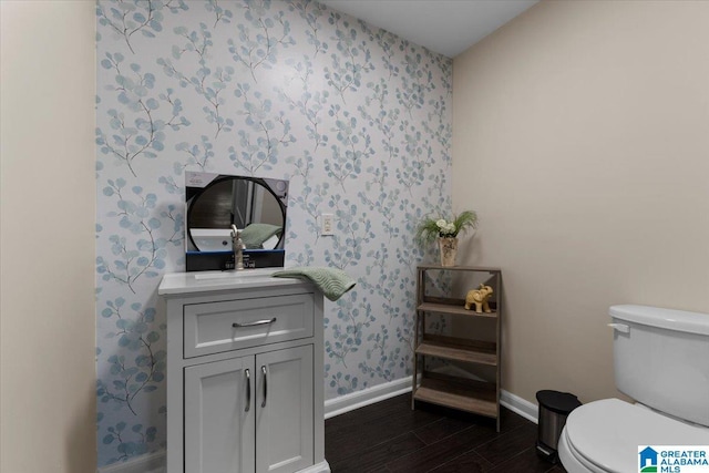 301 Adams Ave E, Oneonta, AL 35121 - bathroom featuring wood-type flooring, toilet, and vanity