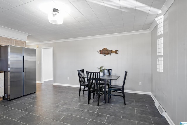 65 Wooley Rd, Brent, AL 35034 - dining area with crown molding, dark tile patterned flooring, and baseboards