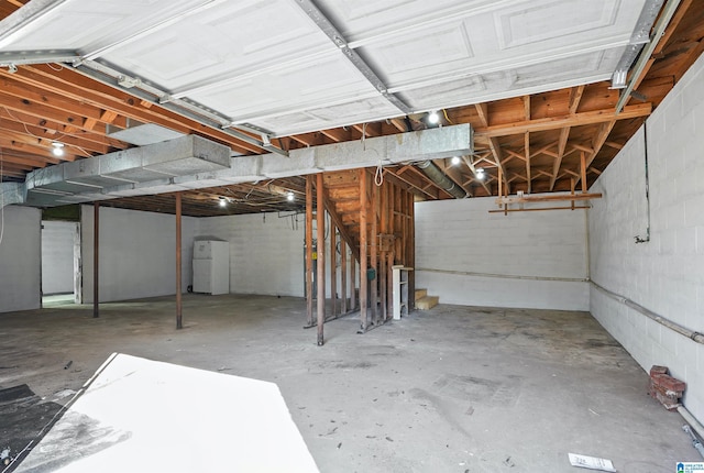 65 Wooley Rd, Brent, AL 35034 - unfinished basement with freestanding refrigerator, concrete block wall, and stairs