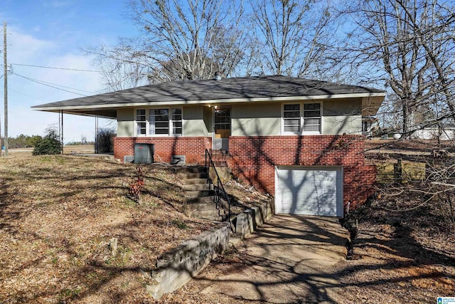 65 Wooley Rd, Brent, AL 35034 - view of front of home featuring brick siding, an attached garage, and driveway