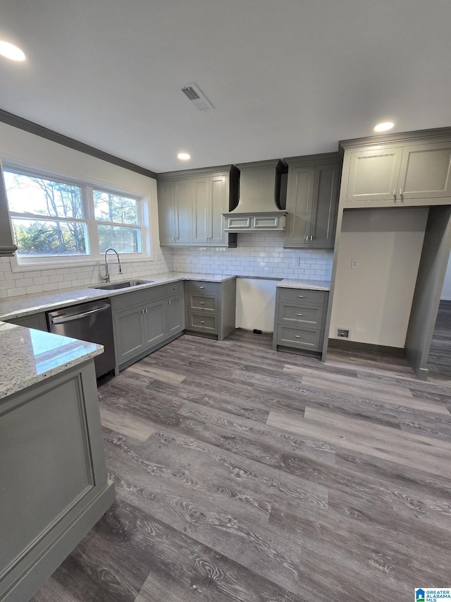 kitchen featuring gray cabinetry, sink, stainless steel dishwasher, and custom range hood