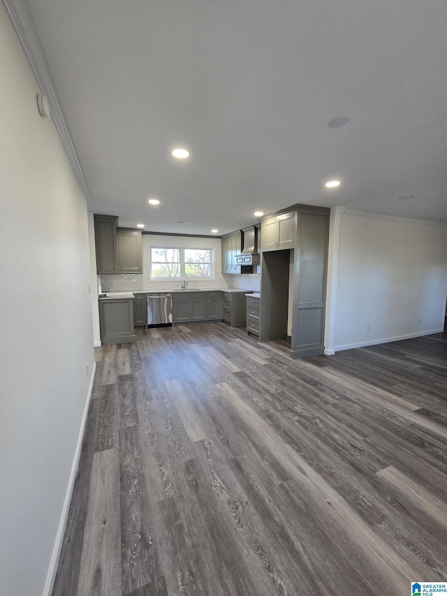 unfurnished living room featuring ornamental molding and dark hardwood / wood-style floors