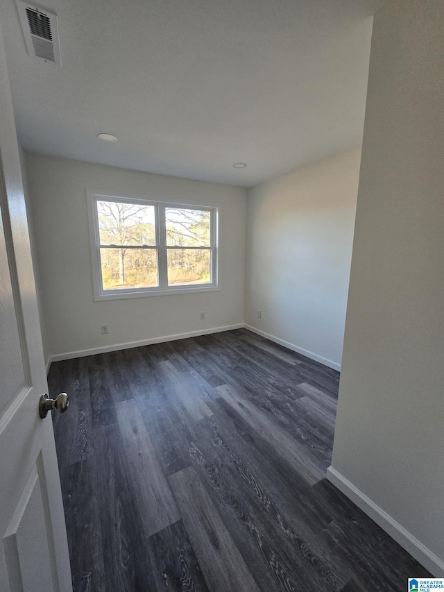 spare room featuring dark hardwood / wood-style flooring