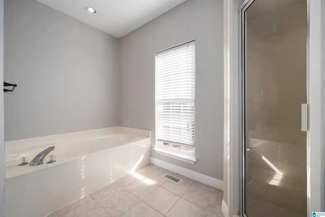 bathroom with plus walk in shower and tile patterned flooring