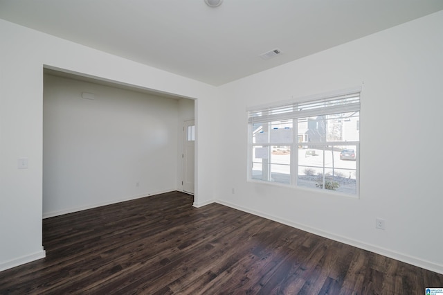 empty room featuring dark hardwood / wood-style flooring