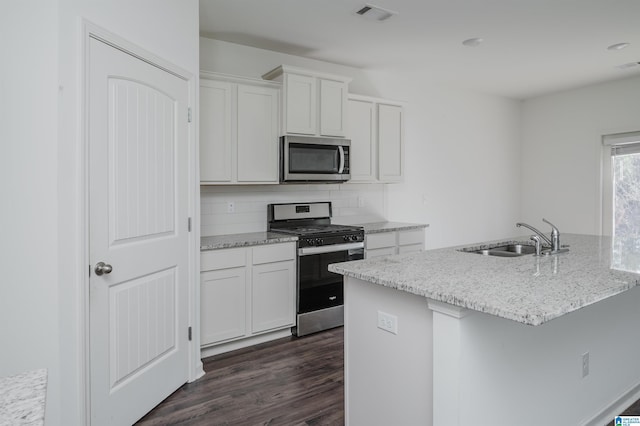 kitchen with white cabinetry, sink, decorative backsplash, and appliances with stainless steel finishes