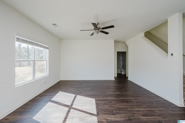 unfurnished room featuring dark wood-type flooring and ceiling fan