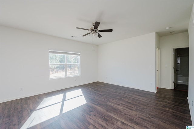 empty room featuring ceiling fan and dark hardwood / wood-style flooring