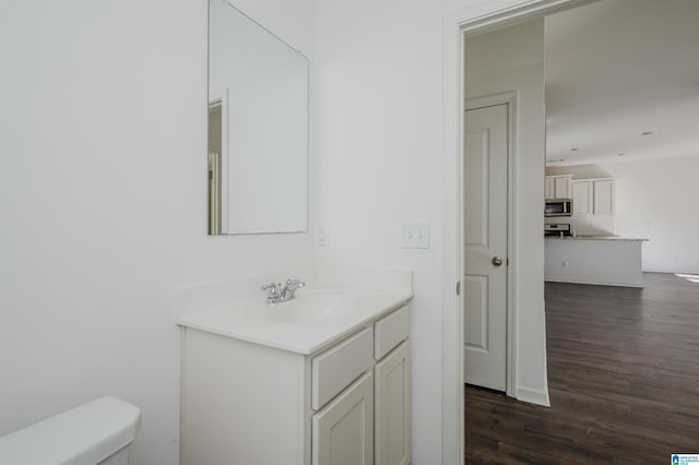 bathroom featuring hardwood / wood-style flooring, vanity, and toilet