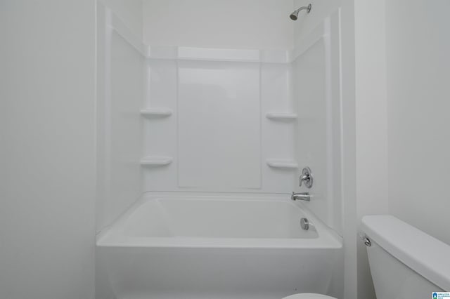 bathroom with bathtub / shower combination and toilet