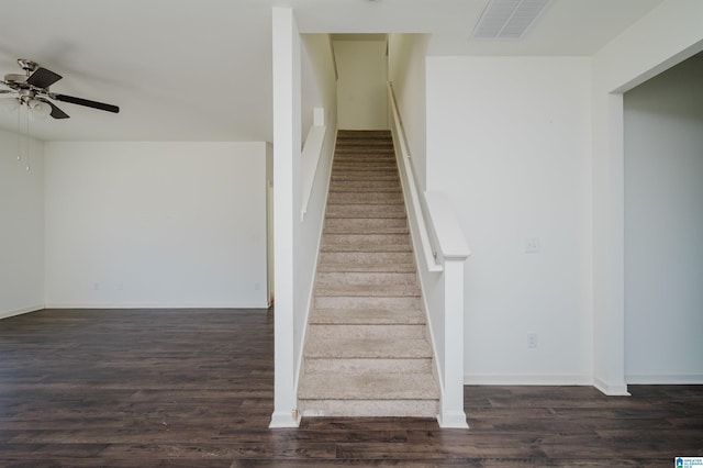 stairway with wood-type flooring and ceiling fan