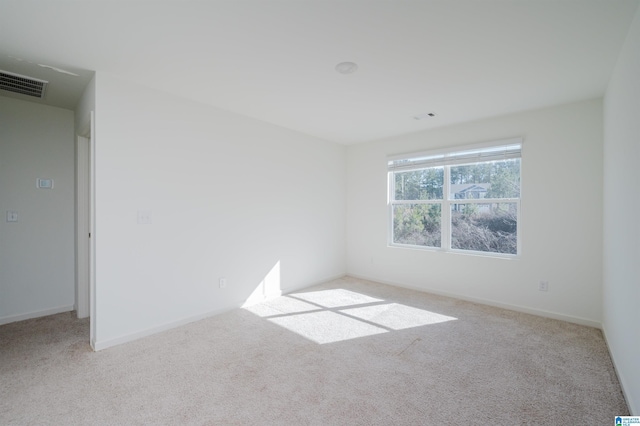 unfurnished room featuring light colored carpet