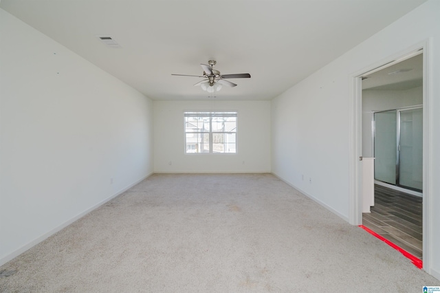 carpeted spare room with ceiling fan