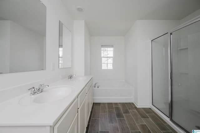 bathroom with vanity and shower with separate bathtub