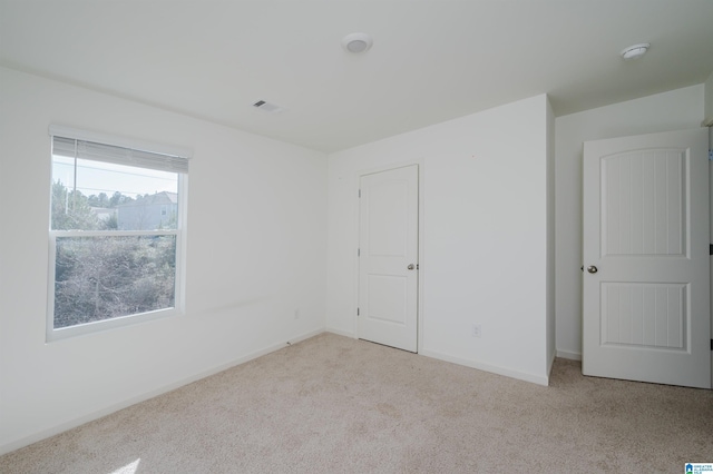 empty room featuring light colored carpet