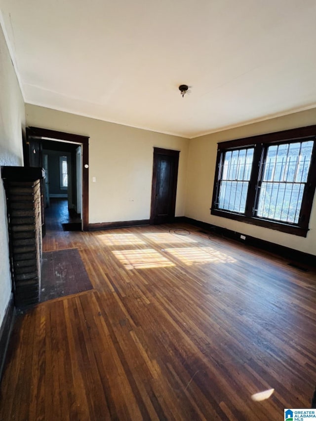 empty room with dark hardwood / wood-style flooring