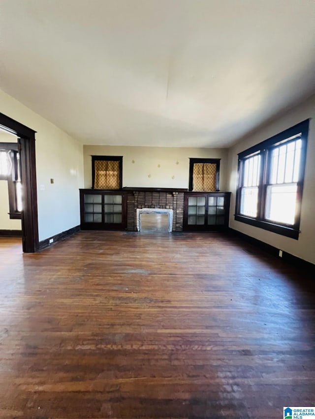 unfurnished living room featuring dark hardwood / wood-style floors