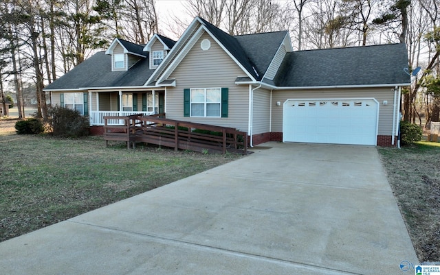 view of front of property with a porch, a garage, and a front yard