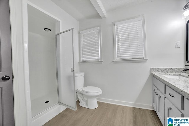 bathroom featuring walk in shower, toilet, wood-type flooring, a textured ceiling, and vanity