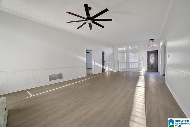 unfurnished living room with crown molding and dark hardwood / wood-style flooring